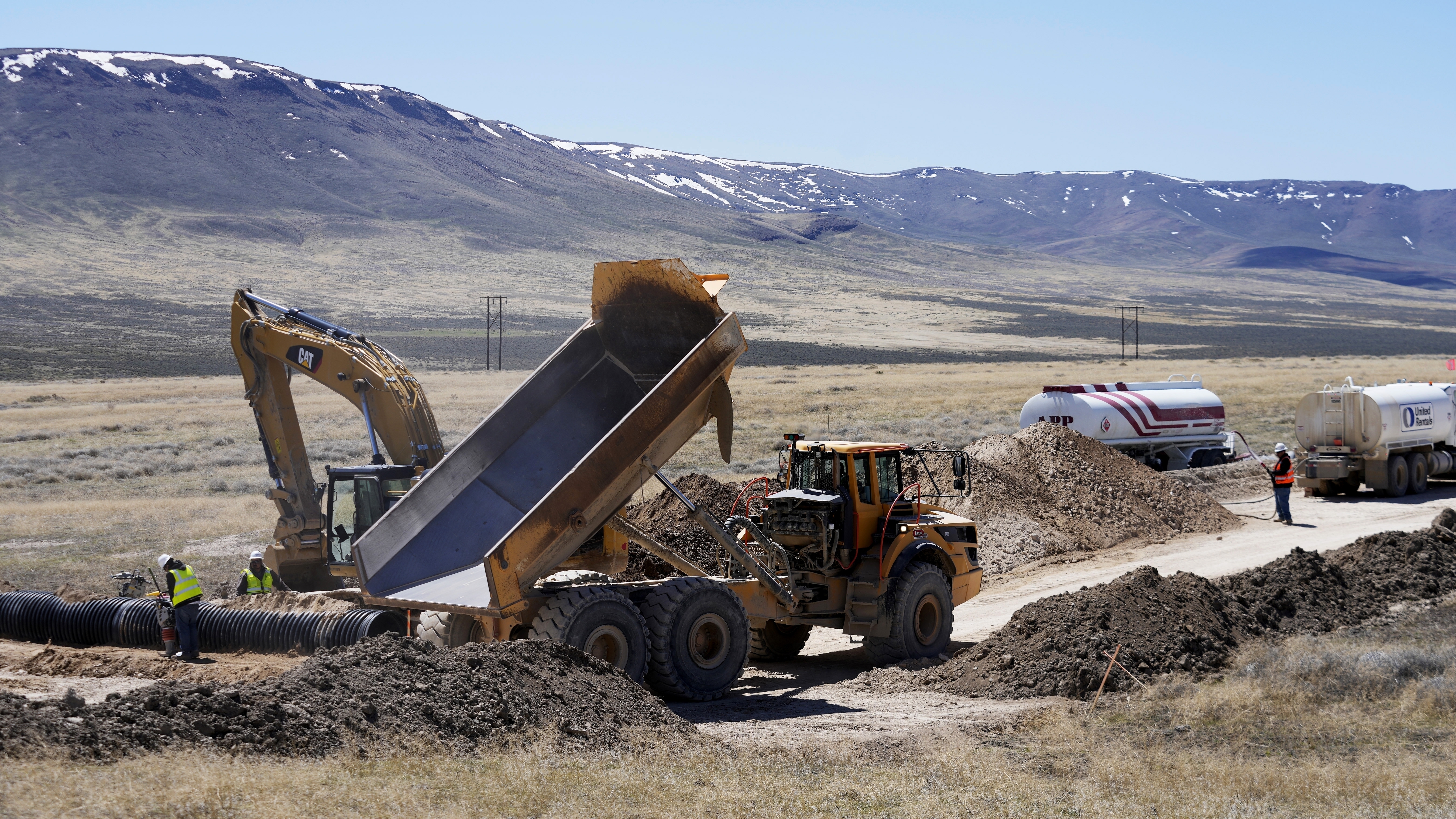 A dump truck and an excavator work on construction at the Lithium Nevada Corp. mine site. A dump truck and an excavator work on construction at the Lithium Nevada Corp. mine site.