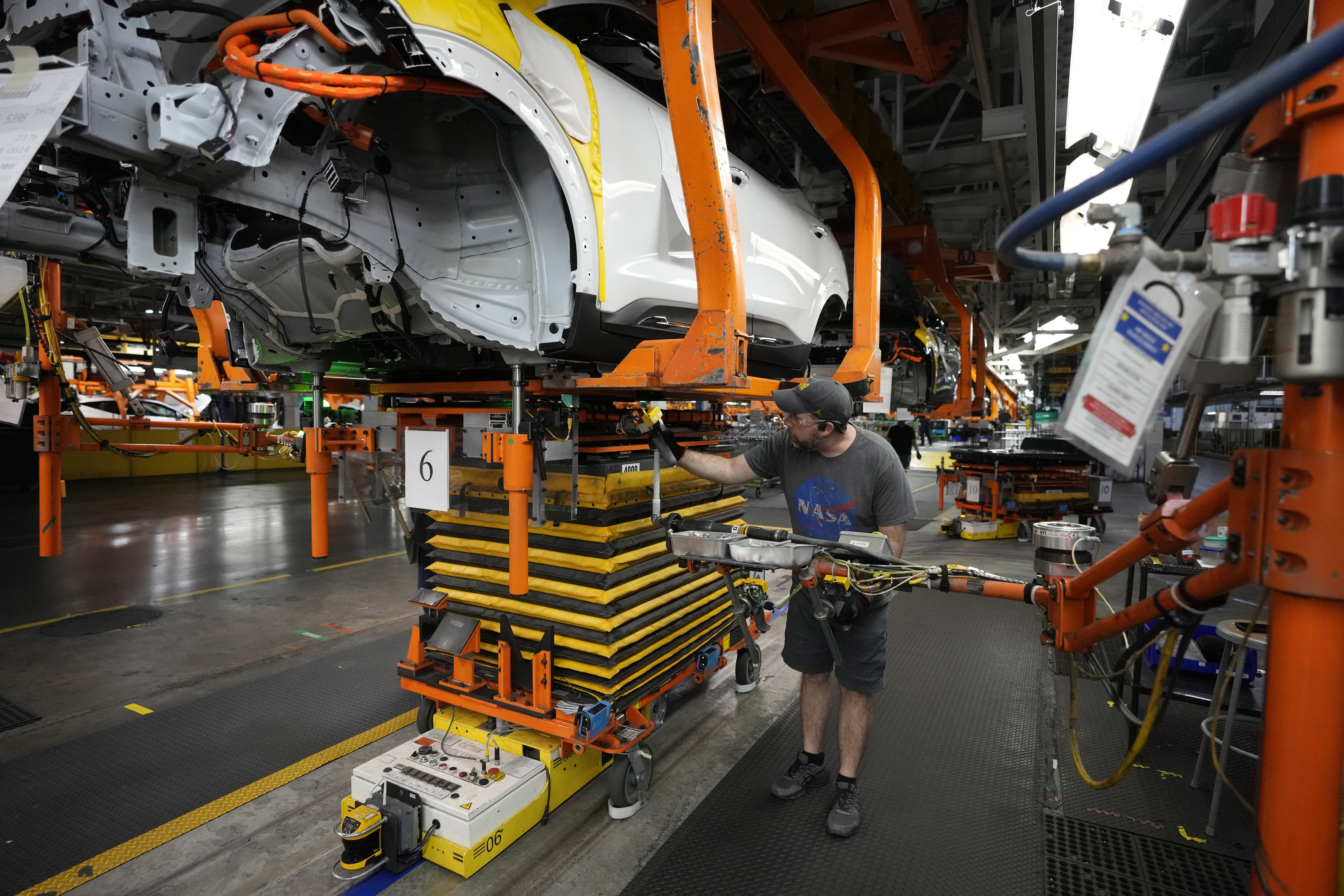 Assembly line worker Ryan Pontillo attaches an LG battery to a 2023 Chevrolet Bolt EV at the General Motors Orion Assembly plant. Assembly line worker Ryan Pontillo attaches an LG battery to a 2023 Chevrolet Bolt EV at the General Motors Orion Assembly plant.