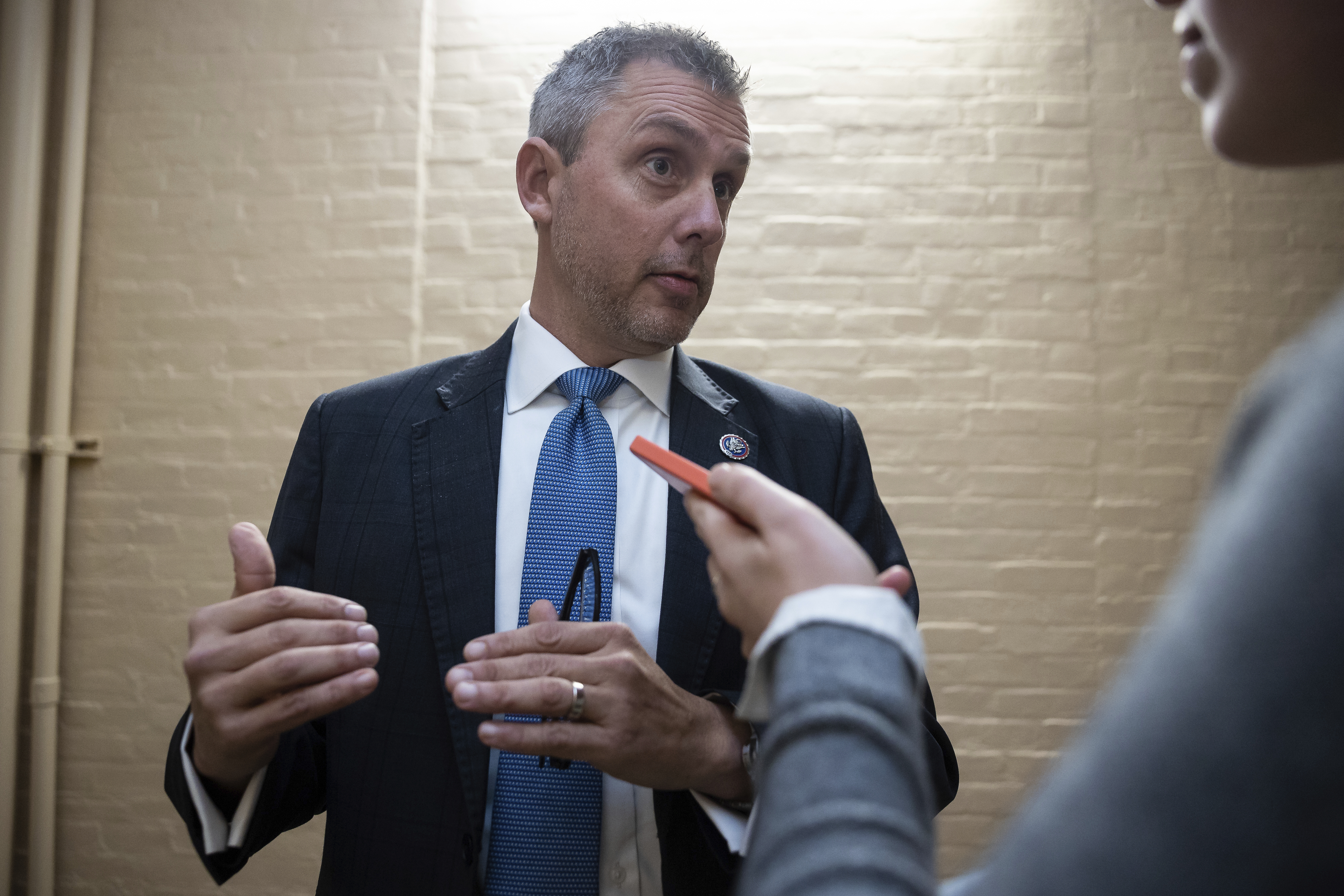 Rep. Kelly Armstrong speaks to a reporter holding up a phone. Rep. Kelly Armstrong speaks to a reporter holding up a phone.