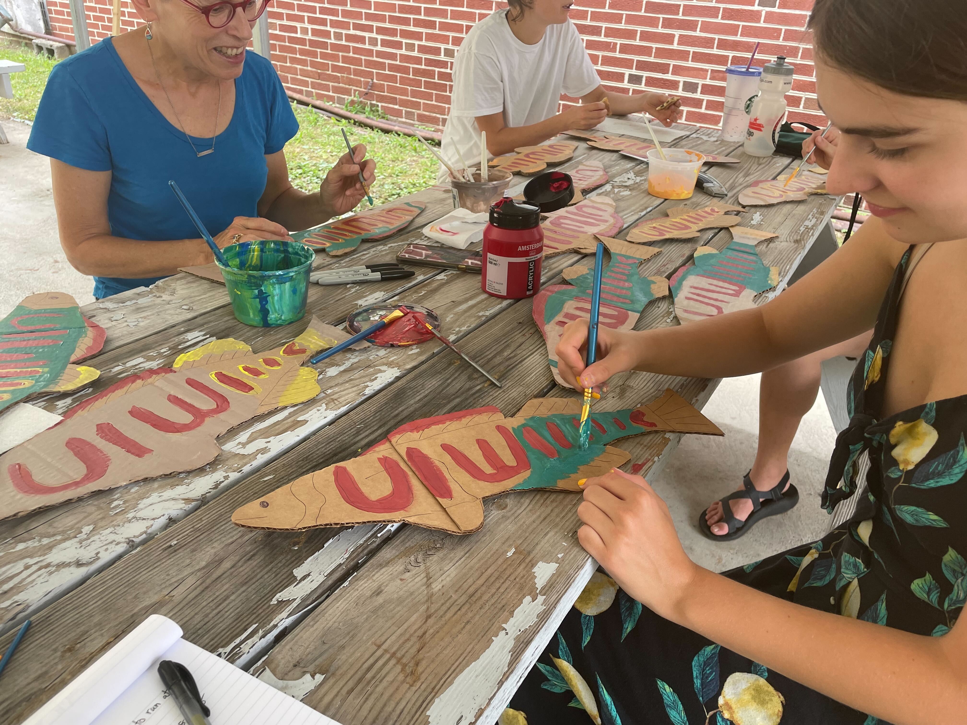 Helena Huber (right) and other opponents of the Mountain Valley pipeline paint cardboard fish in Newport, Va. Helena Huber (right) and other opponents of the Mountain Valley pipeline paint cardboard fish in Newport, Va.